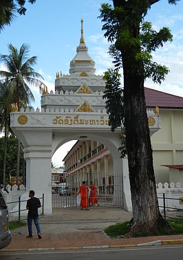 Monks closing a wat gate in the evening